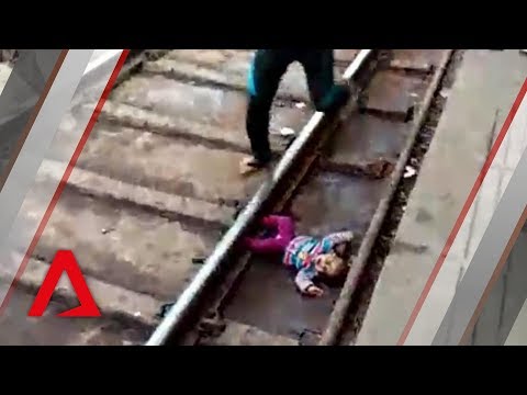 Baby falls onto train tracks in India