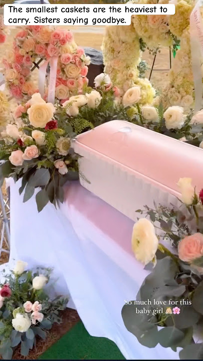 Baby funeral with sisters saying goodbye by loving on the baby one final time by touching the casket