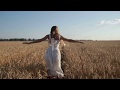 Carefree Woman Running Through Golden Wheat Field 