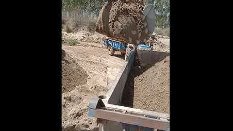 JCB filling  the sand in  trolley