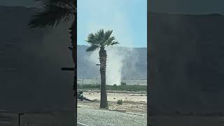Towering Dust Devil Swirls Beside Desert Road