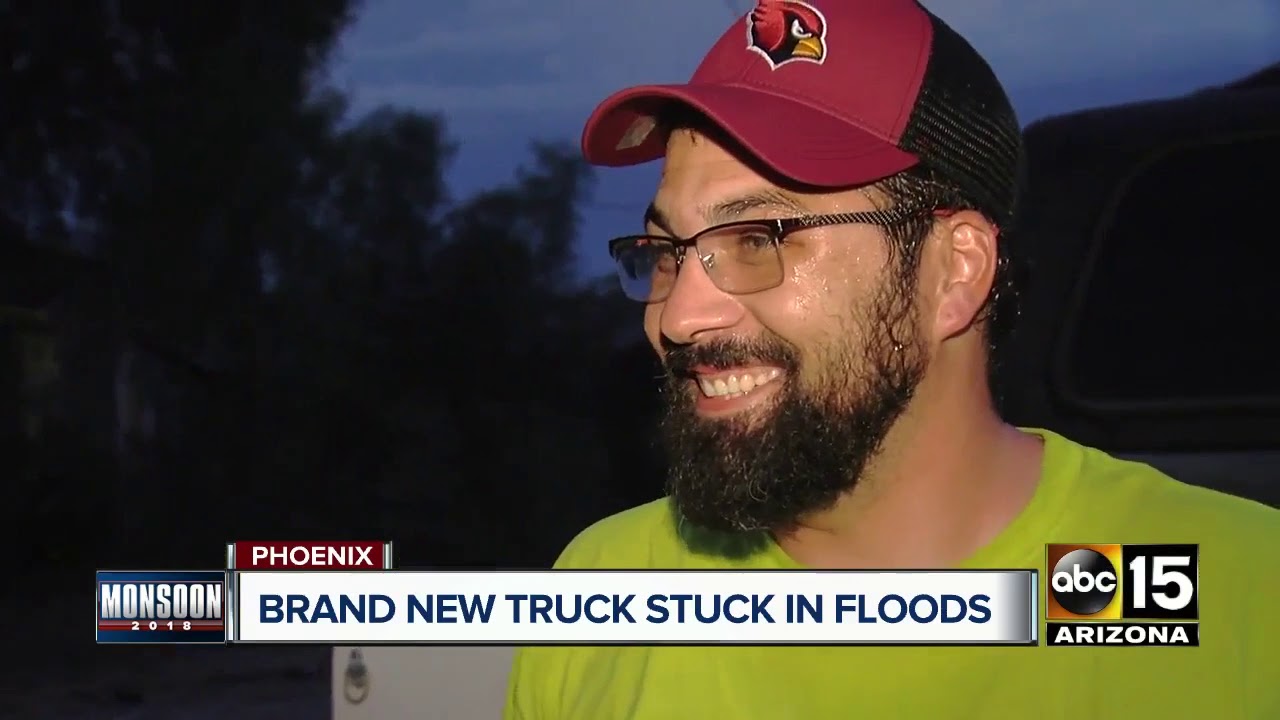 Driver gets brand new truck stuck in Phoenix flood waters - YouTube
