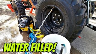 Filling tractor tires with WATER for better traction and balance!