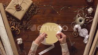 Female Hands Tying a Ribbon Bow on Round Gift Box | Stock Footage - Envato elements