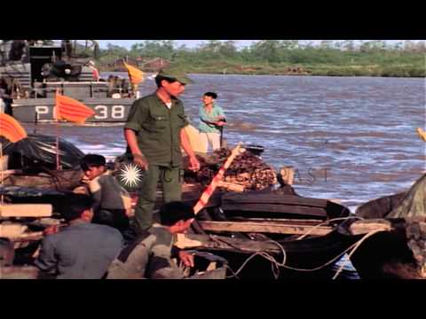 Vietnamese aboard sampans approach a barge complex on the Cua Lon River during Op...HD Stock Footage