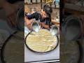 Talented young man making superfast lassi  indian street food  delhi