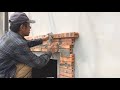 Skilled Professional Construction Workers Decorate The Outside Of Windows From Bricks And Cement