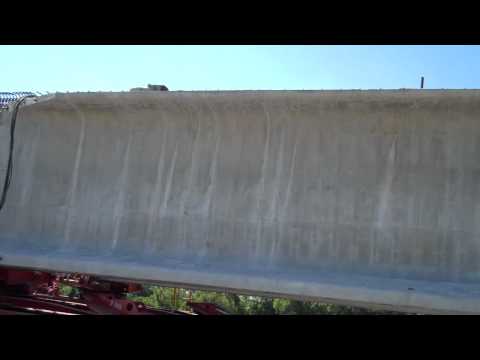 Flatbed Express, operated by The Davies Family, (Mary and Gary, with their sons Duck and James), bring the longest concrete girders ever set in the state of Missouri to the kcICON Project. This interview was conducted at the KDOT "waiting spot" on I-70 and 78th Street in Kansas City, KS. The 150000 pound girders will be used to build a new bridge that will span northbound Interstate 29/35 and carry southbound Interstate 29/35 traffic headed for The Paseo, Independence Avenue, and points beyond. By implementing state-of-the-art best practices from around the country, MoDOT is incorporating a Nebraska Department of Transportation innovative design to flyover all new northbound interstate lanes with a single span bridge, saving both time and money. The Paseo Blvd. ramp bridge will be completed in the fall of 2010, and traffic will reopen from southbound Interstate 29/35 to The Paseo.