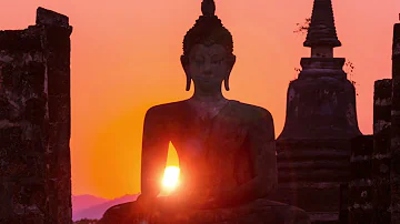 Fields of Passion: Radiant Sunset Behind Stone Buddha