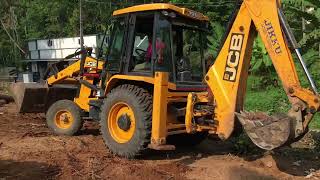 jcb 3dx cleaning land by removing waste