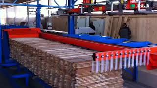 Infeed layers of lumber with adjustable grippers on the frame