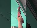 installing drywall screws into the green ceiling boards using an automatic collation screwdriver