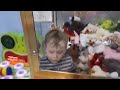 Three year old boy climbs into toy machine