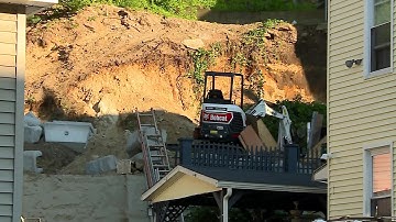 Video Now: 2 workers rescued after retaining wall collapse