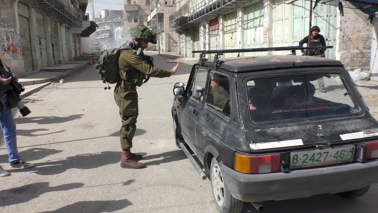 Israeli soldiers commandeer Palestinian car for protection, Hebron, 16 Feb. 2018