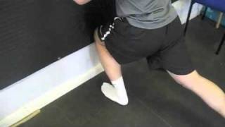 How to Perform Knee to Wall Touches