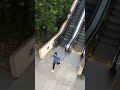 Guy Slides Down Escalator While Talking On Phone - 1160039