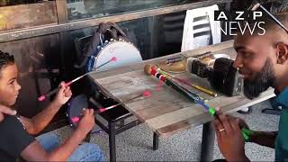 Atesh Indarjit of Dynamic Rhythms Tassa out of Ft. Lauderhill, Florida, teaches his son some Tassa