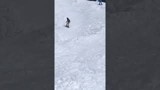 Snowboarder jumps hill and lands on kid skier