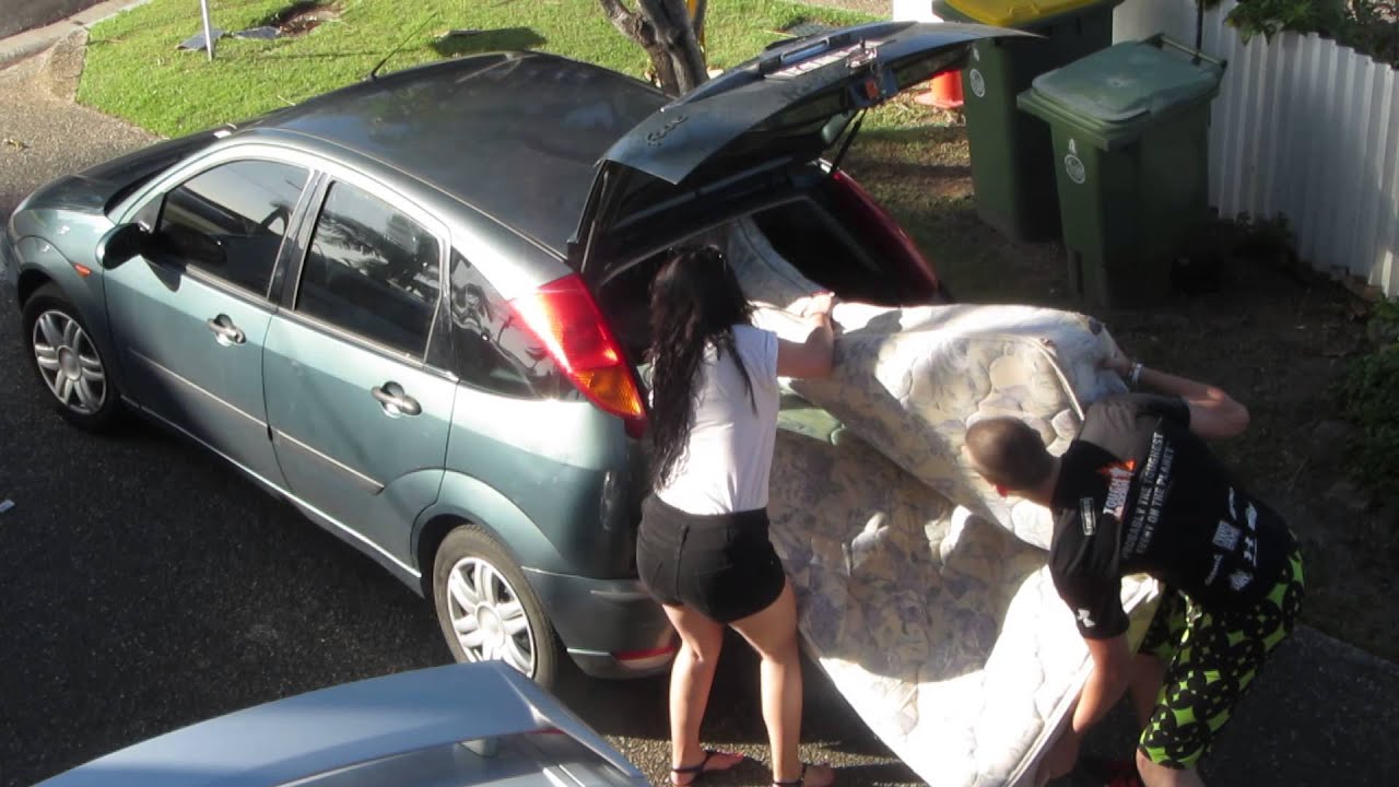 twin mattress on top of car