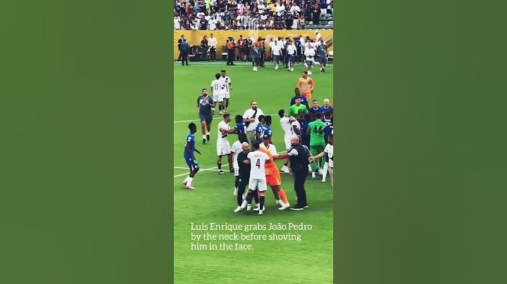 Luis Enrique grabs João Pedro by the neck before shoving him in the face.