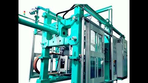SMED Shape moulding machine with robot arm to pick and stack products.