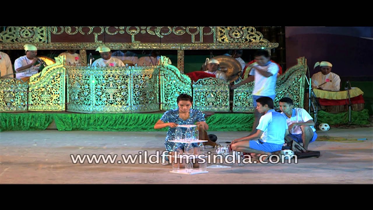 Juggler arranging glass bottles in India