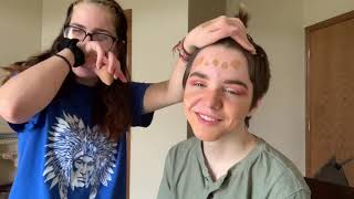 Doing my little brothers makeup.