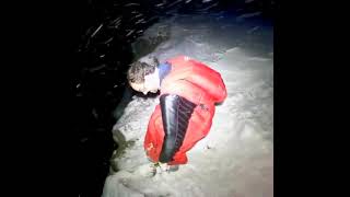 Wingsuit at night with a flare in the snow