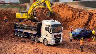 RC Excavator Digging Through a Hill with Trucks to Make Way for a New Road Part 1 !!