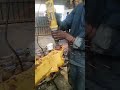 REPLACING OLD BUSHES FROM EXCAVATOR'S AXLE END IN MECHANICAL WORKSHOP USING SPANNER/ HAND TOOLS