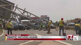 Truck plows into sign over I-440, causing major delays in Raleigh