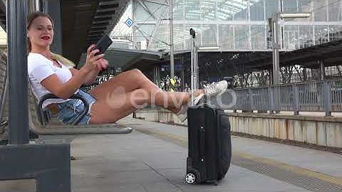 A Young Beautiful Woman Takes Selfies on a Train Station Platform | Stock Footage - Envato elements