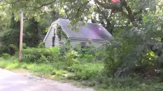 Over grown  Abandoned two story house  in the ghetto urban exploring
