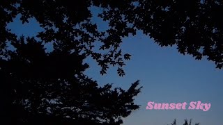 Natural Darkening of The Sky at Sunset with Clouds Drifting By