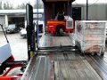 Palfinger Crayler CR truck mounted forklift unloading a truck from oneside