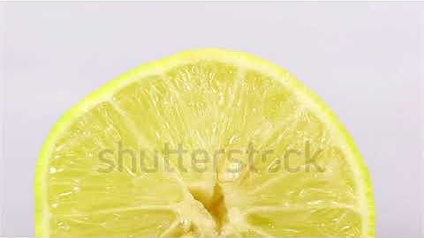 stock footage dolly shot of lemon slice on white background macro shot1