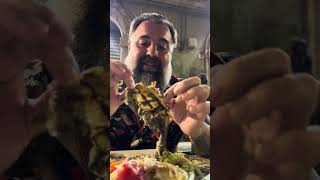 Sicilian master deboning local grilled fish in Sicily