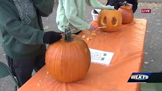 Volunteers carving pumpkins for Jack O'Lantern Stroll