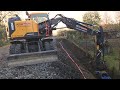 Volvo EWR 150E working on trail rail / Gabion wall / 4K