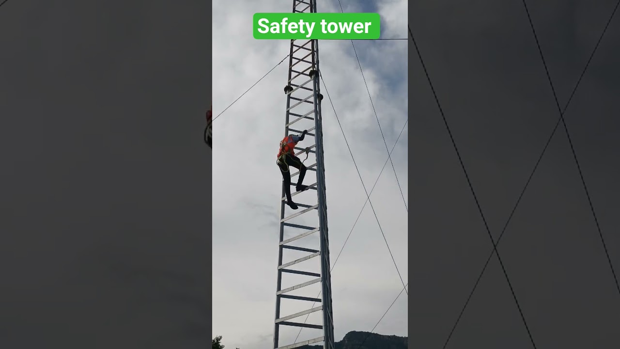 Using a safety belt to climb the tower. 