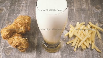 Slow motion pour beer and fast food top view