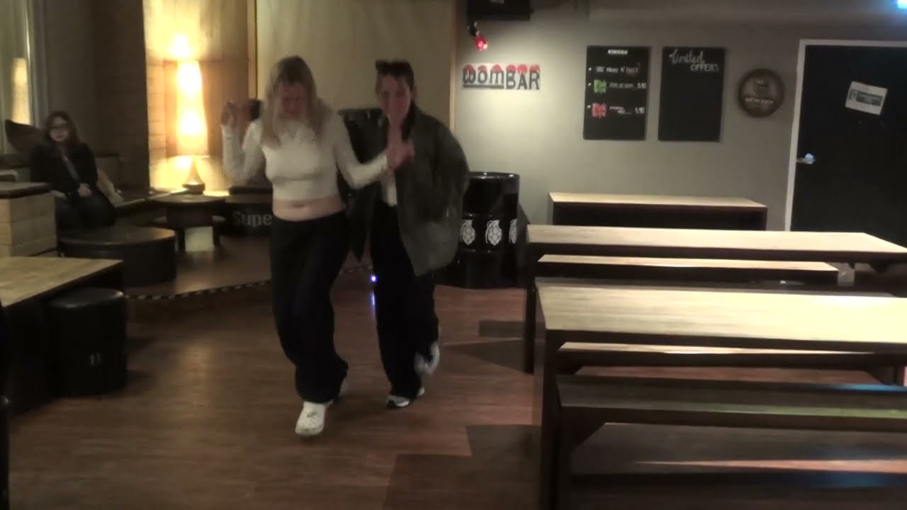 Rachel Johnstone and Jorja Honeyman showing the typical Scottish folk dance at the Wombat's Hostel