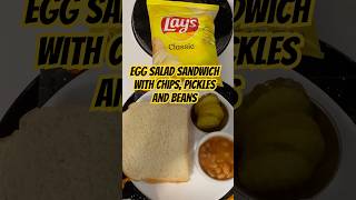 Masters tournament lunch item for the third round. Egg salad sandwich with chips, beans and pickles