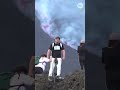 Visitors hike near Mount Etna as lava streams from active eruption