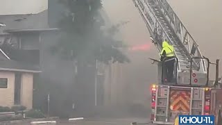 Houston firefighters work to control apartment fire as strong storms move through