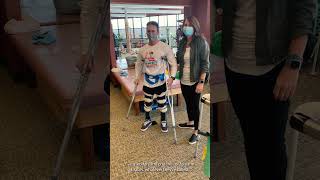 Paraplegic Using Crutches to Walk With Leg Braces