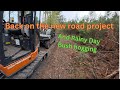 Excavator road work and bushhogging in the rain