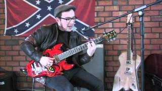 Adrian Whyte the Devil drives a Valiant on the Devil Ali Kat Guitar