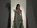 Shimmering embellishments, a sleek silhouette, and a dramatic removable train